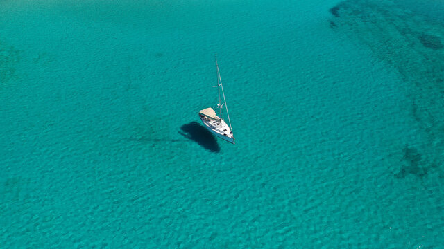 Aerial drone photo of luxury sail boat anchored in tropical exotic paradise bay with turquoise sea