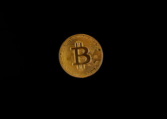 Bitcoin crypto coin captured against back background