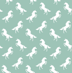 Vector seamless pattern of flat unicorn silhouette isolated on mint green background