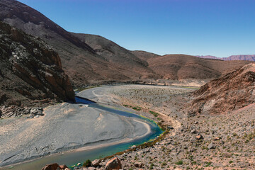 Africa Morocco desert Atlas mountains nature rock landscape with river palm under blue sky hot weather 