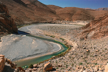 Africa Morocco desert Atlas mountains nature rock landscape with river palm under blue sky hot weather 