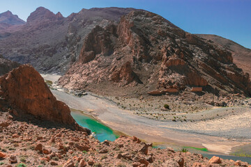 Africa Morocco desert Atlas mountains nature rock landscape with river palm under blue sky hot weather 
