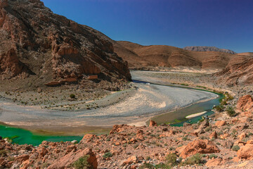 Africa Morocco desert Atlas mountains nature rock landscape with river palm under blue sky hot weather 