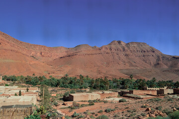 Africa Morocco desert Atlas mountains nature rock landscape with river palm under blue sky hot weather 