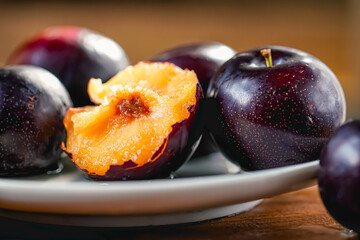 Fresh black plums on cutting board