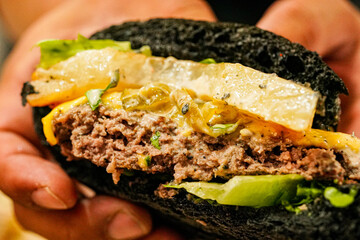 Black burger with delicious patties and cheese