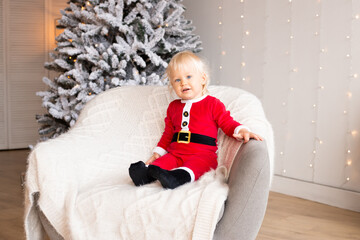 Cute little boy in festive decorated room for Christmas