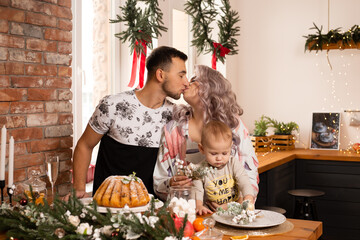 kissing couple family on kitchen enjoying the Christmas magic.