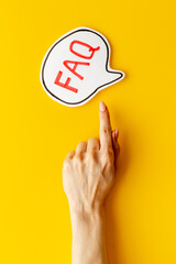 Hands with faq - frequently asked questions - text on paper bubble
