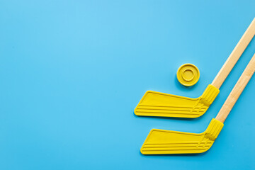 Competitive sports equipment with hockey sticks and puck. Top view