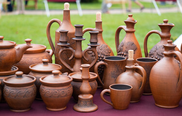 Fototapeta na wymiar Earthenware at market. Jugs, plates, jugs, bottles from clay