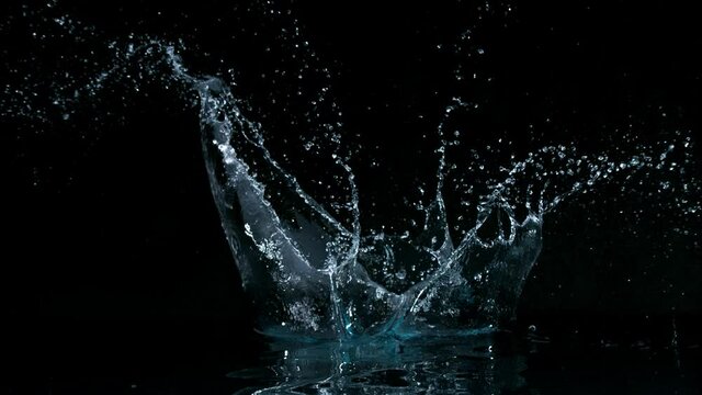 Super slow motion of big water splash on black background. Filmed on high speed cinema camera, 1000 fps.