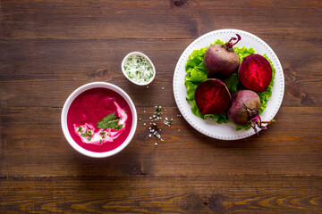 Cream soup made of red beet with raw beet roots