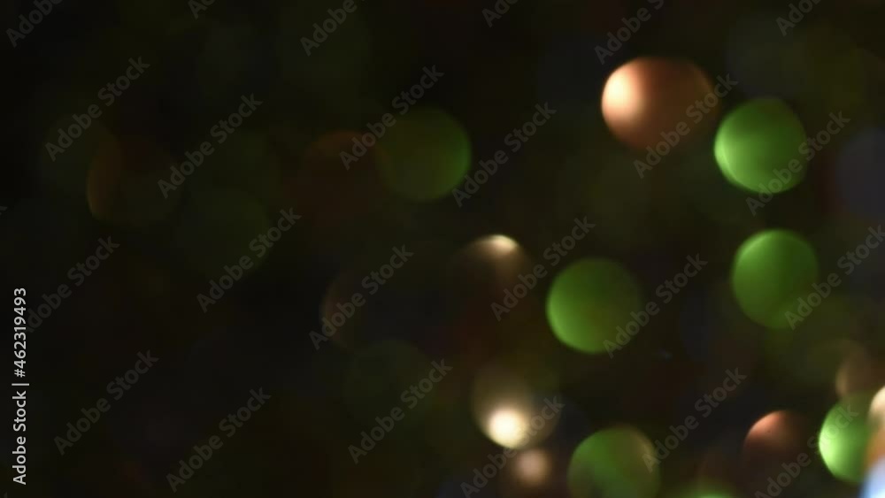 Wall mural slow movement of light over multicolor bokeh with fading. rounds of illuminated light move from righ