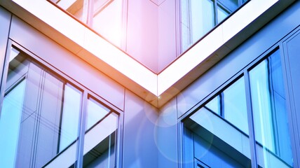 Obraz premium Modern office building with glass facade on a clear sky background. Transparent glass wall of office building.