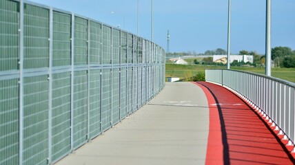 Bicycle path and sidewalk through the highway bridge.