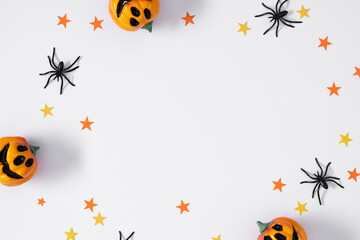 Halloween decoration concept. Spiders, stars, pumpkin, flat lay, top view, copy space
