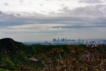 Los Angeles in the hazy distance with a white fence in the foreground from Griffith Park 