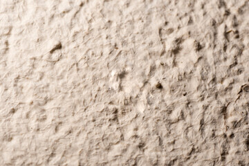 Background texture of rough exterior wall painted beige.
