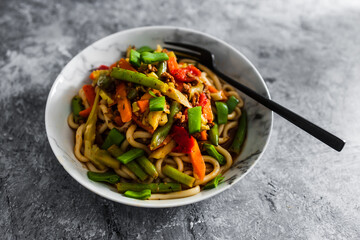 vegan mixed vegetables stir fry with udon noodles, healthy plant-based food