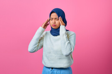 Portrait of young Asian woman looking dizzy and having headache