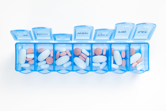 Blue color weekly medicine organizer isolated on white background