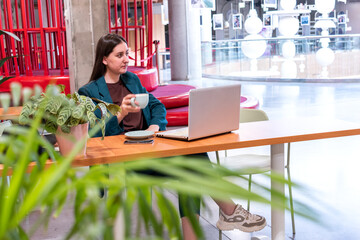 Young woman in suite is working on computer.