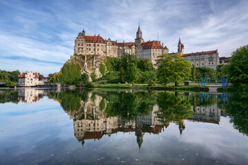 Fototapeta na wymiar Hohenzollern Castle in Sigmaringen, Germany is reflected in the water of the Danube river at daytime