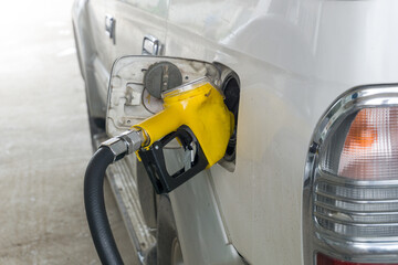 A transport van refuels with diesel fuel at a rural service station.