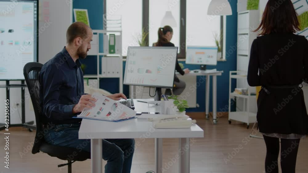 Poster business manager using computer and papers with charts for marketing strategy. entrepreneur with cor