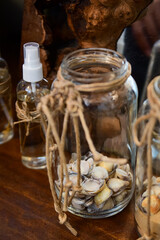 decorative glass jars with rustic bow and sea shells
