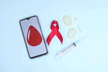 red ribbon and medical device symbol against HIV virus isolated on blue background