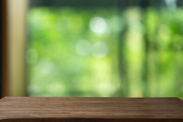 empty on wood table on green background.