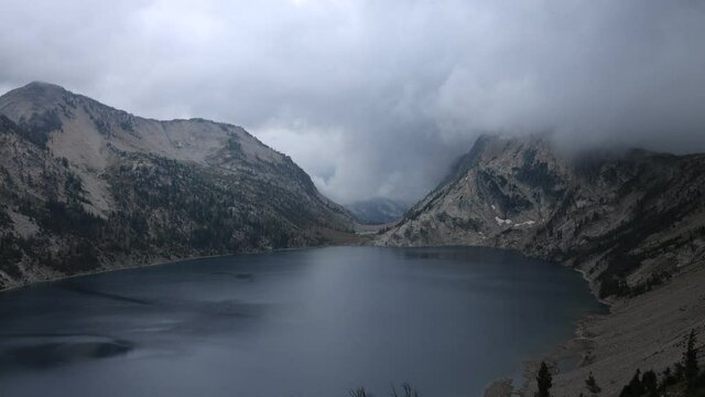 A time-lapse of rainclouds passing over Sawtooth Lake, a large alpine lake in the Sawtooth National Recreation Area in Custer County, Idaho as seen on a summer morning. Mt. Regan is in the distance.