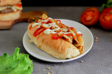 hotdog with tomato sauce and cheese. This image is suitable for making menus and advertisements
