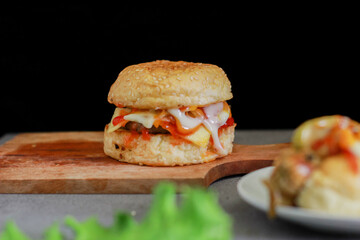beef burger and hotdog with tomato sauce and lettuce.
