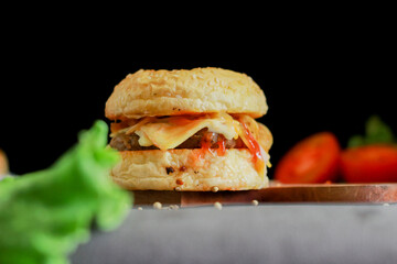 beef burger and hotdog with tomato sauce and lettuce.