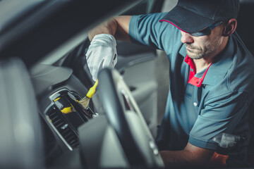 Automotive Worker Cleaning Modern Car Interior