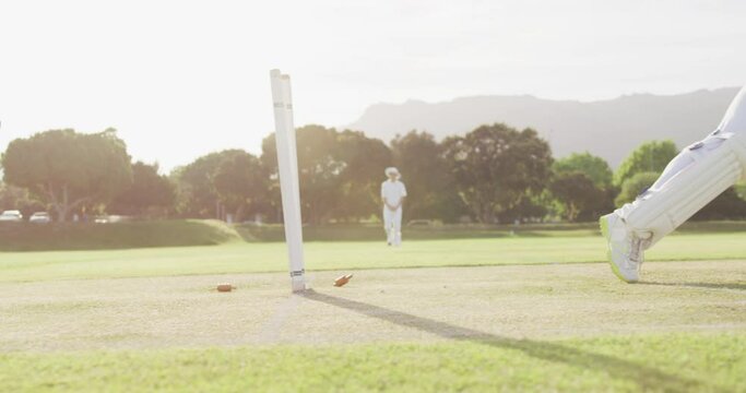 Cricket player missing the ball on a pitch