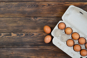 fresh homemade farm eggs in eco packaging on a concrete table, the concept of delivery and packaging of organic products.