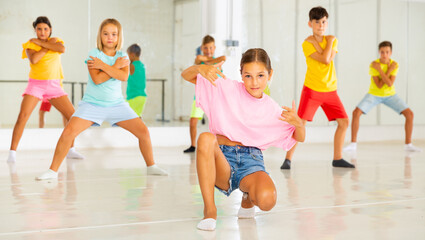 Young girls and boys performing hip-hop dance in studio. - obrazy, fototapety, plakaty