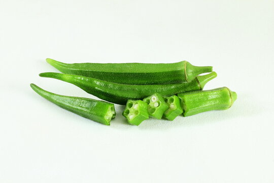 fresh okra vegetable isolated with cut slice on white background