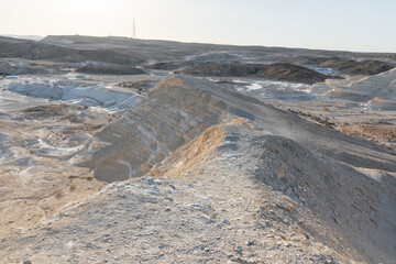 Beautiful lunar landscape. Wight and smooth hills in various shapes in a desert landscape. The whitish, rounded, winding, and smooth chalk rocks. Israel. High quality photo