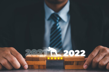 Virtual screen people pushing away the text of 2021 in preparation for the start of the new year...