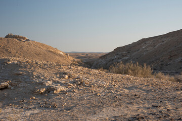 Beautiful lunar landscape. Wight and smooth hills in various shapes in a desert landscape. The whitish, rounded, winding, and smooth chalk rocks. Israel. High quality photo