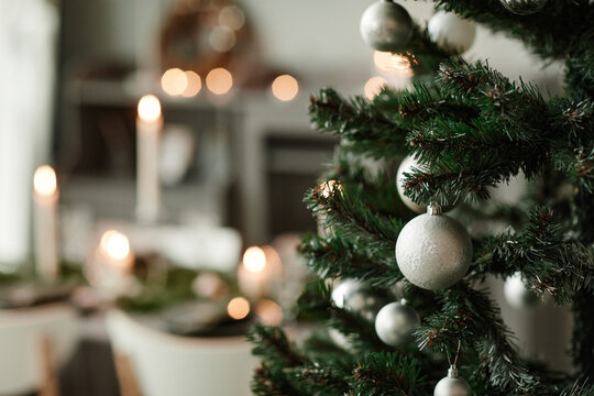 Close up background image of Christmas tree in elegant dining room decorated with grey ad silver tones, copy space