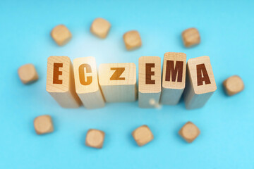 On a blue background, wooden cubes and Jenga with the inscription - ECZEMA