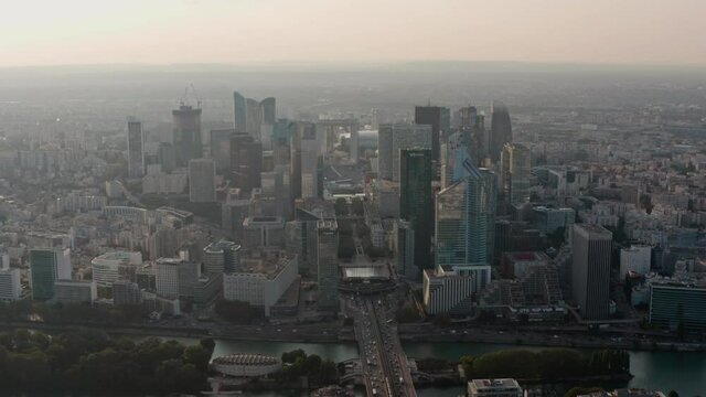 Circling drone shot of La Defence Paris Business District at sunset
