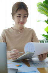 Business woman hand holding pen and data document, account or saving money or insurance concept.