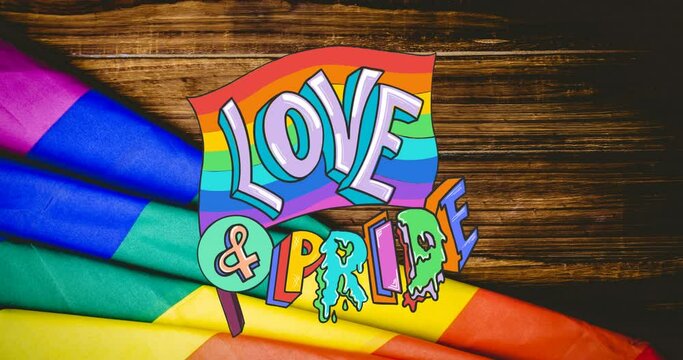 Animation of rainbow love and pride over rainbow lying on wooden background